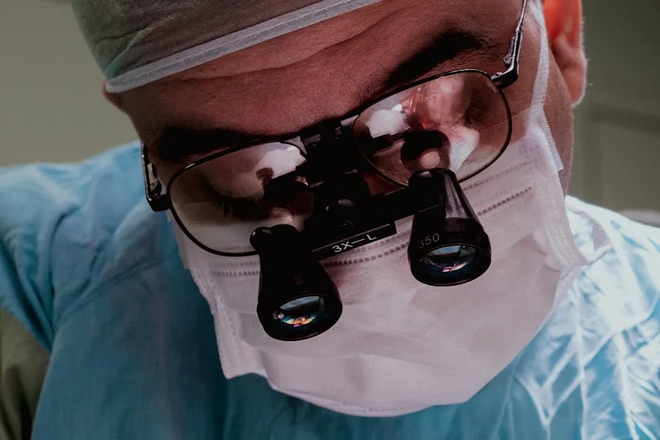 Close-up of web-admin, a fellowship trained mohs surgeon NJ at PS Dermatology and Surgery, wearing surgical loupes and mask, ready for a procedure.